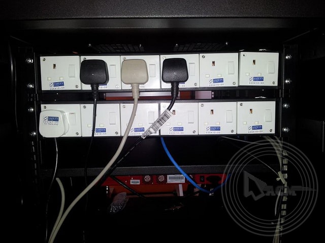 3 pin plug on extension cord in server rack
