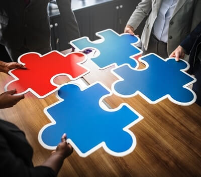 Business team assembling puzzle pieces